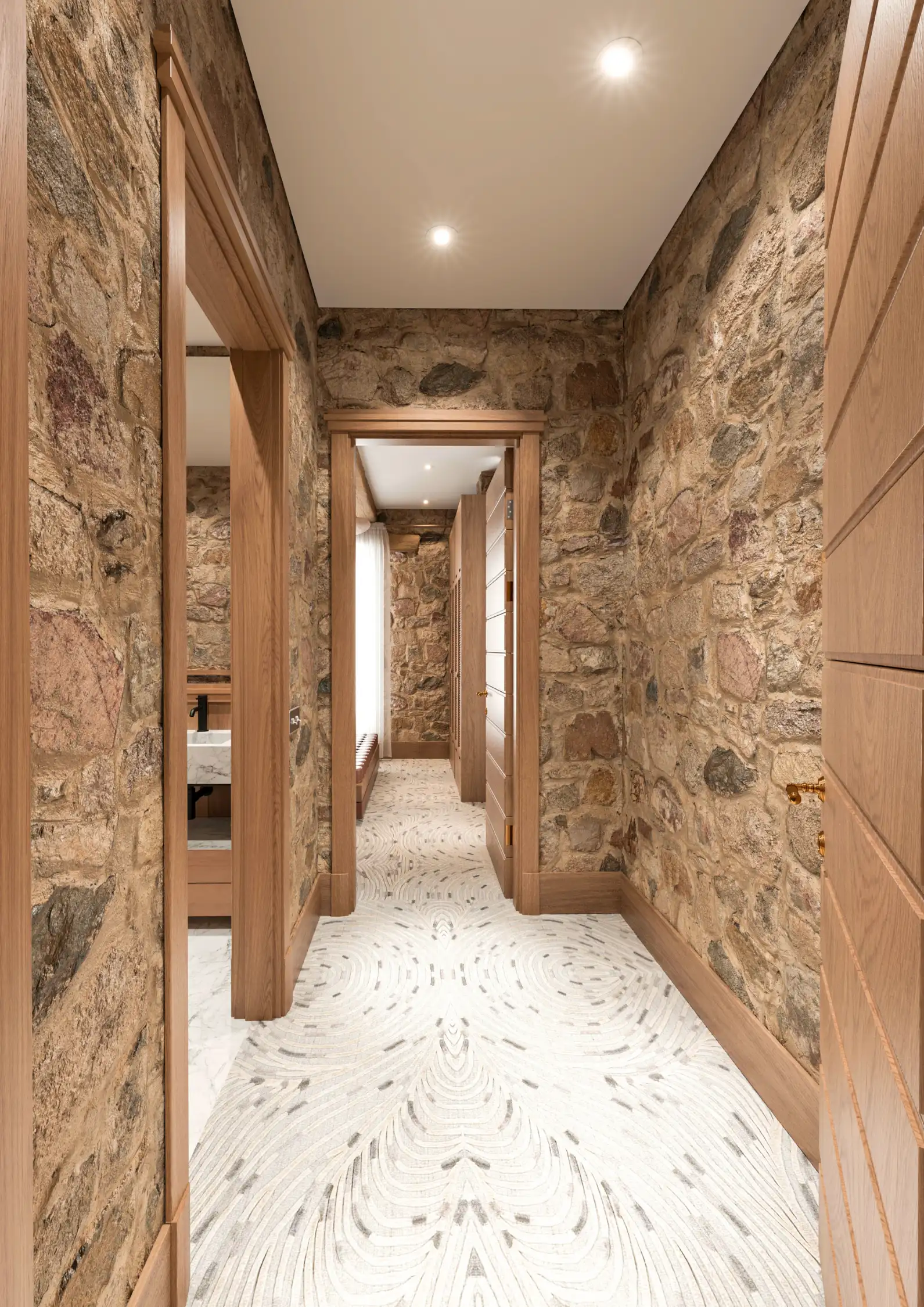 High-end marble bathroom design integrated into raw stone architecture.